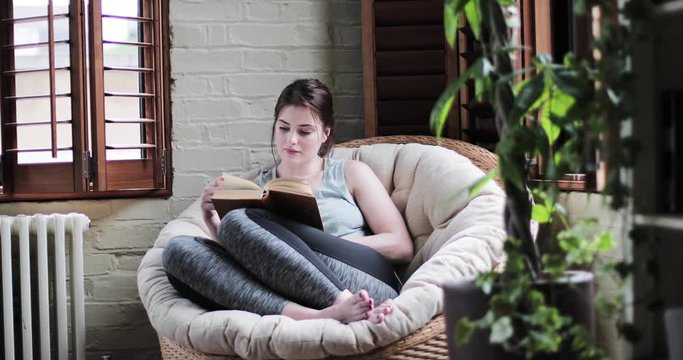 Young adult female reading a book