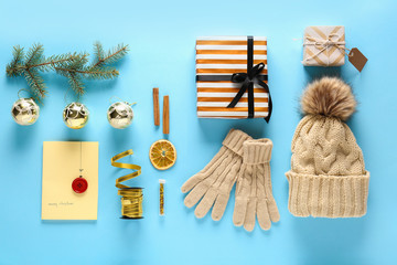 Beautiful Christmas composition with winter accessories and gift on color background