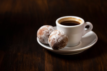mini cheese donuts and a cup of coffee
