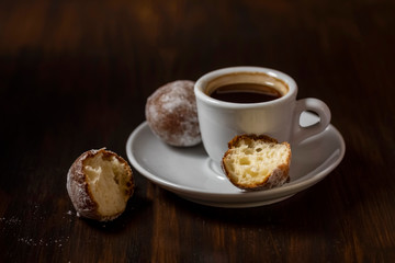 mini cheese donuts and a cup of coffee