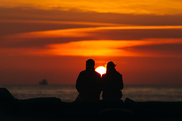 Fototapeta na wymiar Silhouette of couple at sunset time