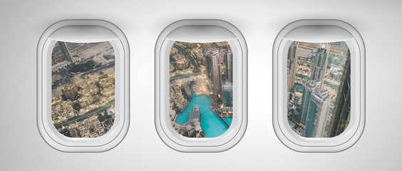 Airplane interior with window view of Dubai City, UAE. Concept of travel and air transportation
