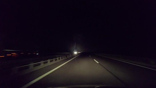 Driving in evening concept, drive past truck in tunnel, and continue on dark road, time lapse