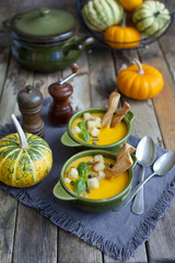 Creamy pumpkin soup topped with pumpkin 	