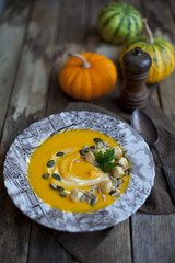 Creamy pumpkin soup topped with pumpkin 	