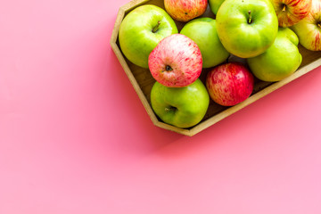 Healthy diet concept. Fresh apples in tray on pink background top view copy space