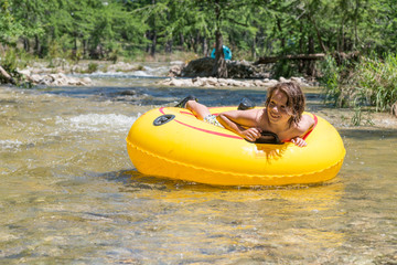 USA, Texas, Boy tubing the Frio River