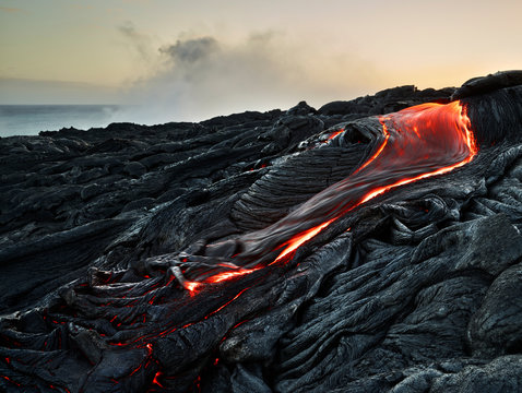 Lava flowing from Pu'u O'o' at Hawaii Volcanoes National Park against sky