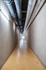 Pipes over empty corridor inside factory, Stuttgart, Germany