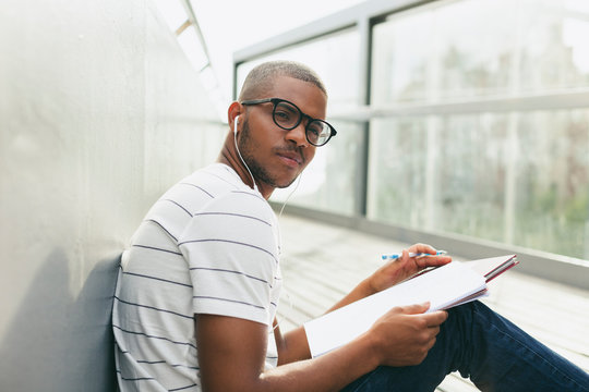 Young Afro-american man studying language