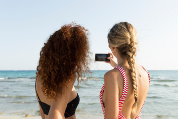 Best friends taking a selfie at the beach
