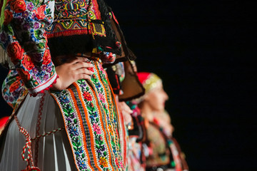 Close up on detail of young Romanian female dancer traditional folkloric costume. Folklore of...
