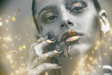 Gold Paint smudges drips from woman face, lips and hand, lipgloss   dripping from sexy lips, golden...