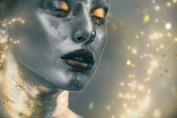 Gold Paint smudges drips from woman face, lips and hand, lipgloss   dripping from sexy lips, golden liquid drops on beautiful model girl's   mouth, gold metallic skin make-up