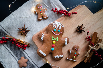 Gingerbread cookies with cinnamon, anise and lights on a wooden table. Christmas concept. Flat lay.