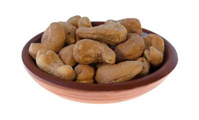Bowl of roasted and salted cashews on a white background.