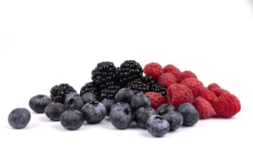Beautiful set of red raspberries, blue blueberries and black shiny blackberries