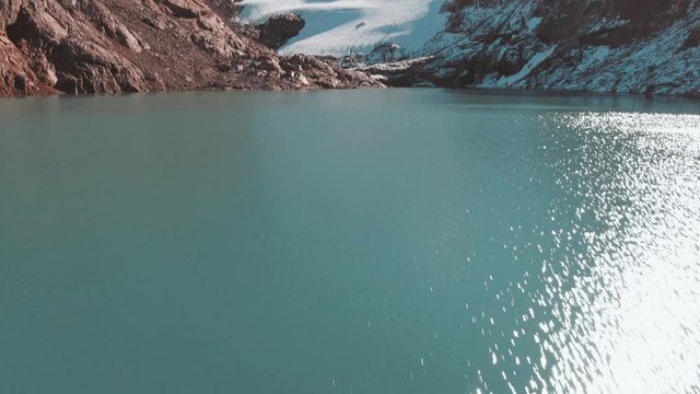 Aerial panoramic footage of young girl hiking the Mount Fitz Roy trek, showcasing the beautiful Patagonia mountain landscape