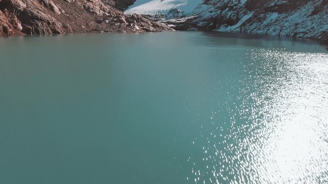 Aerial panoramic footage of young girl hiking the Mount Fitz Roy trek, showcasing the beautiful Patagonia mountain landscape