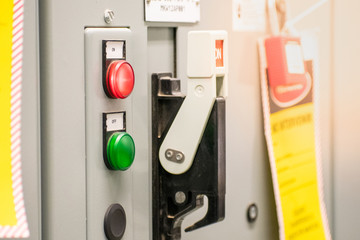 Industrial electrical supply board, status indicator button and switches.