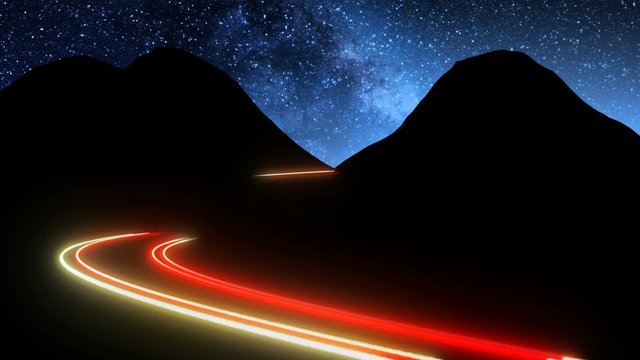 Night traffic white headlights and red tail lights of cars traffic moving fast along mountain road leaving glowing trails against night mountains landscape, starry sky moving beyond the horizon