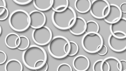 Abstract illustration of randomly arranged white rings with soft shadows on gray background