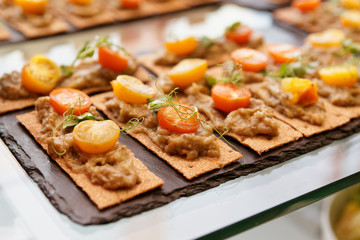 Crisp bran breads with eggplant mash and cherry tomatoes