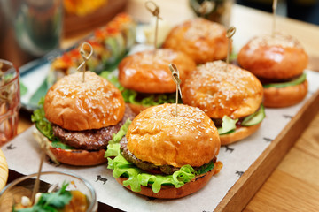 Hamburgers on wooden board