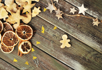 Christmas cookies, cinnamon, dried oranges on wooden background.