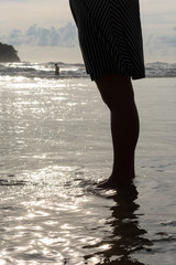 Fototapeta na wymiar women's legs in the sea waves