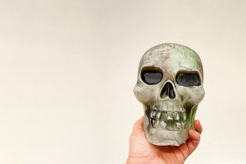 Halloween decoration glowing skull in the hand. Empty space for text input. Halloween concept