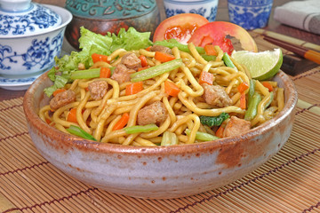Vegetarian food : stir fried noodle with tofu, carrots and green vegetables. Chinese vegetarian noodle for vegetarian festival.