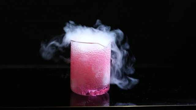 priming of a chemical reaction in a beaker containing reactive substances.