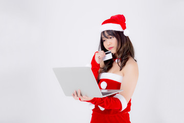 Beautiful portrait young asian woman in Santa thinking idea and holding credit card and laptop computer for shopping online in Christmas holiday isolated on white background, girl purchase and pay.