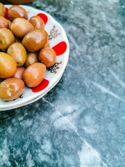green olives in the red white cup top view