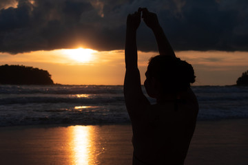 silhouette of woman at sunset on the kata beach