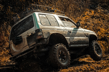 Motion the wheels tires and off-road that goes in the dust on the sand. Drag racing car burns rubber. Extreme. Off-road car. Tires in preparation for race. © Volodymyr