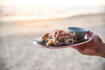 Grilled squid plate on beach sea