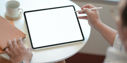 Cropped shot of businessman writing the idea on blank screen tablet