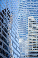 Obraz premium a composition of a curved glass building and a straight high skyscraper in new york city