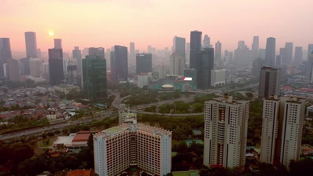Aerial view of semanggi intersection in Jakarta while in high pollution air covering the city. trucking motion.