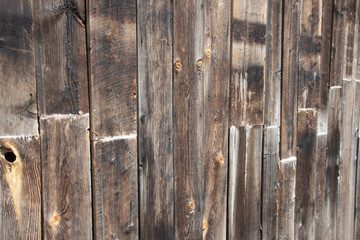 An old wall constructed of vertical wooden boards
