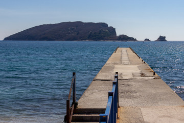 Pier on Beach Greco, Budva, Montenegro leading to Saint Nikola Island