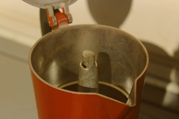 red geyser coffee maker on white background. moka pot