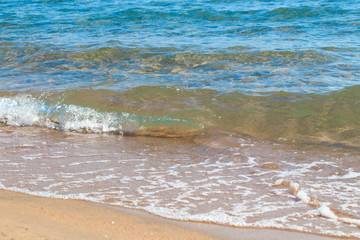 sandy beach and blue sea wave. Beautiful natural background. Tourism and travel.