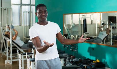Fototapeta na wymiar Cheerful African man at gym
