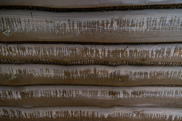 Boards polished with a protective coating from atmospheric exposure are covered with raindrops