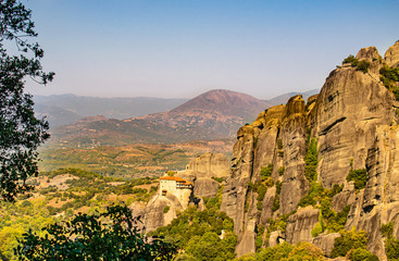 Monastery Meteora Greece. Stunning panoramic landscape. View of mountains and green forest against epic blue sky with clouds. UNESCO heritage object.