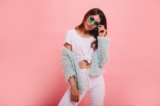 Fashionable full length image of  woman with long ginger hair happy laughing to camera. Indoor photo of blissful caucasian girl in trendy sunglasses and mint green  jacket.