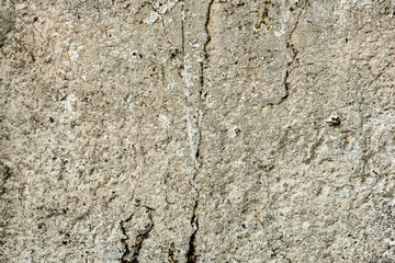 Texture of a concrete wall with cracks and scratches which can be used as a background